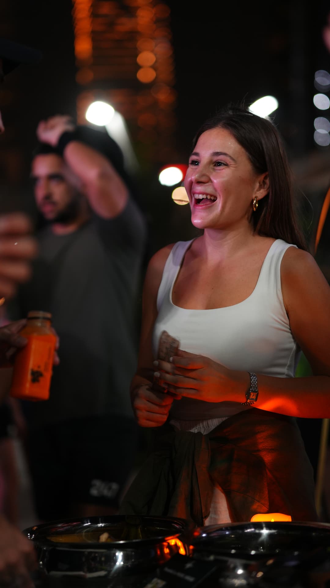 A guest laughing beside the food table at the end of the night