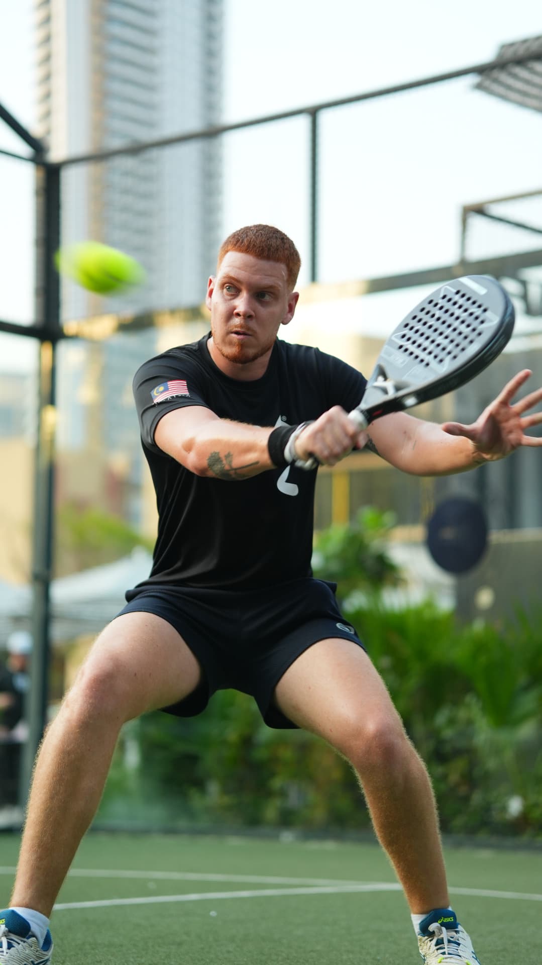 Two players smiling together on the padel court
