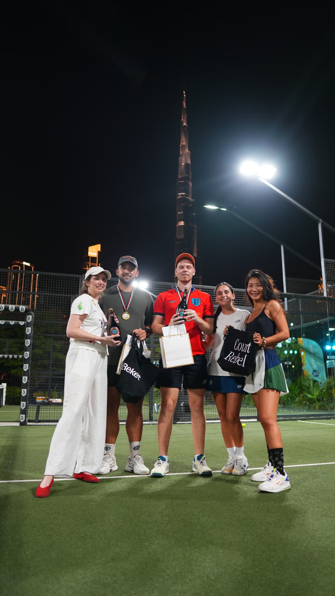 Players with their prizes and gift bags on court after the matches