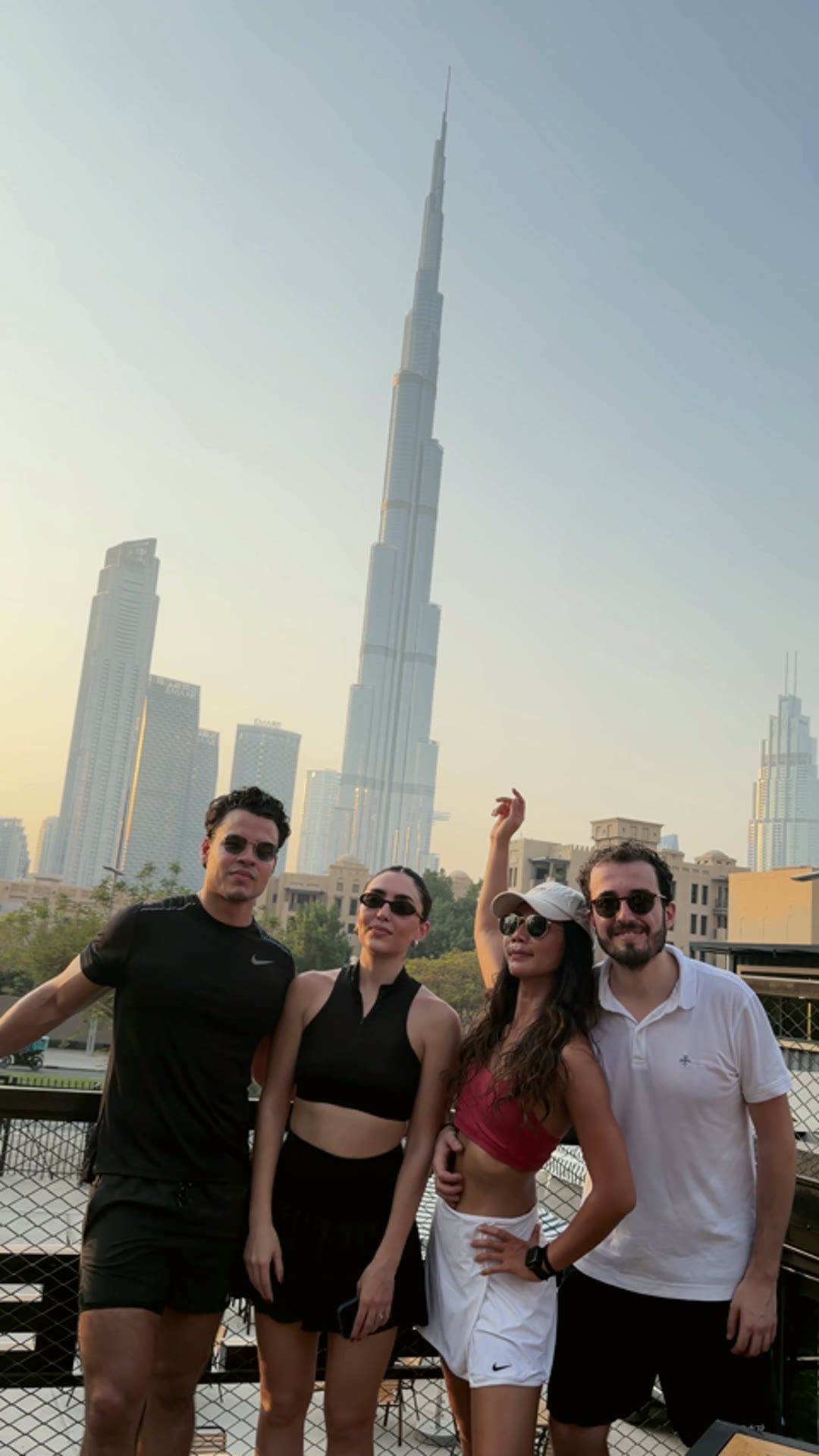 Four friends together at golden hour with the Burj Khalifa behind them
